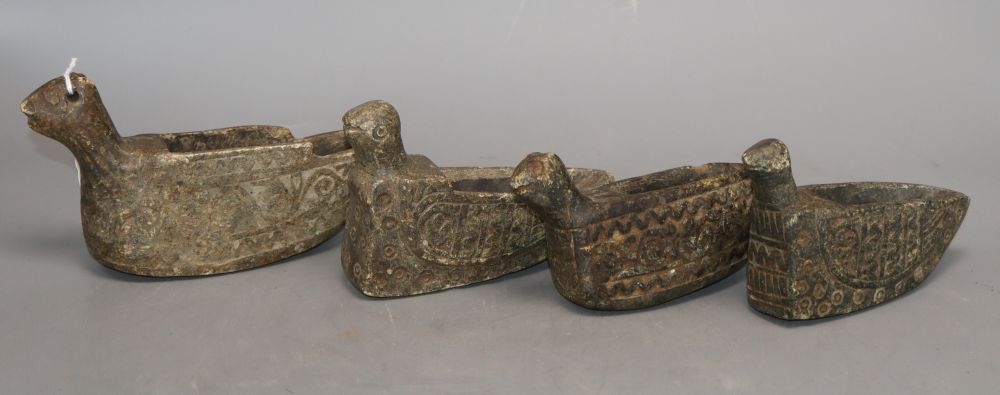 Four Middle Eastern carved stone oil lamps carved in the form of birds, longest 18cm